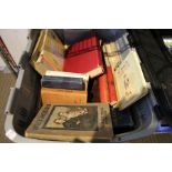 A grey crate and a burgundy crate of books various including observers guides.