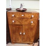 A walnut veneer tallboy with ceramic pink rose handles.