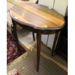 A mahogany oval topped table on four plain legs.