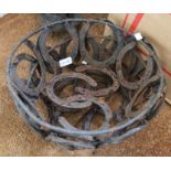 Two metal hanging baskets formed from horseshoes.