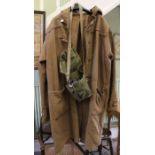 A second World War probably Naval cold weather duffle coat with a bagged gas mask.