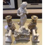 A selection of cast plaster figurines. To include a mantel timepiece bookends etc.