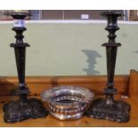 A pair of silver plated candlesticks together with a wine bottle coaster