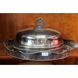 A silver plated oval gallery tray with a food dome and serving dish.