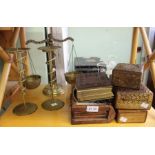 Eastern carved/book boxes with brass weighing scales and a pair of candlesticks.