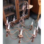 An eight sconce bronze effect light fitting with rope twist centre
