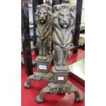 A pair of brass stylised Lion firedogs
