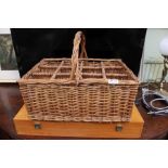 An empty wine carry box together with a wicker wine basket