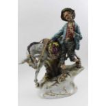 A Capodimonte ceramic figure of a man with his donkey, the pannier full of fruit, 39cm