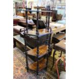 A four tier walnut inlaid whatnot, 129cm high excluding finials