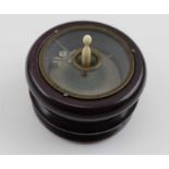 A 19th century treen gambling device, bone spindle rotates a platform with a pair