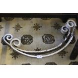 A pair or wrought iron decorative supports.