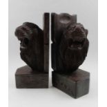 A pair of carved wood bookends, lion mask decoration, 23cm high