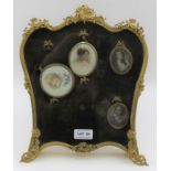 A gilt brass decorative easel frame for displaying miniature paintings, hinged, glazed front panel.