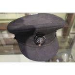 J.W. Taylor and son - a military peaked cap with badge