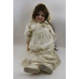 An Armand Marseille, bisque head doll, with composition body, dressed. Inscribed to the back of the