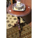 A 20th century mahogany finished circular topped table on barley twist turned column 71 x 46 cm.