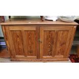 A large Victorian pitch pine two door cupboard, 92cm x 142cm
