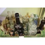 A box containing a large selection of vintage bottles