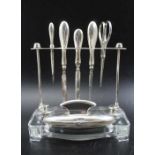 Albert Carter, A silver & glass manicure stand, Birmingham 1930, together with various silver handle