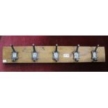 A set of five numbered hat and coat hooks
