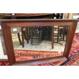 An oak framed rectangular bevel edged mirror