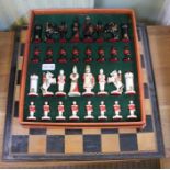 A cased 20th century figural chess set plus wooden board