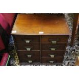 An Edwardian mahogany table top eight drawer filing cabinet