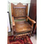 A pair of part 18th design, probably Lancashire armchairs, with rose carved panel back & solid seat