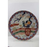 A Japanese Imari porcelain charger, painted and gilded with vase of flowers decoration, 37cm in diam