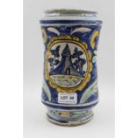 A majolica wet drug jar, hand painted floral, and architectural panel, 23cm high