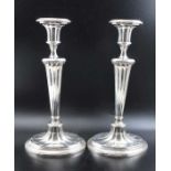 A pair of late Victorian, Adam design silver plated candlesticks, stylised urn form nozzles on taper