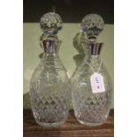 J.B. Chatterley & Sons Ltd. A pair of silver mounted cut glass spirit decanters, with stoppers, the