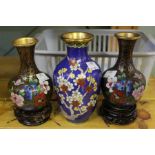 A pair of Cloisonné vases on stands and one other.