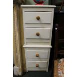 A pair of cream painted wooden bedside chest of drawers