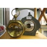 A brass and glass domed lens desk clock, together with a slate cased barometer.
