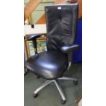A black leather upholstered high backed modern swivel office chair