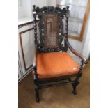 A Carrollian design open armchair, carved frame, with crown crest, scroll arms, cane seat and back