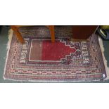 A small woven woolen prayer rug.