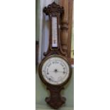 A walnut carved barometer thermometer