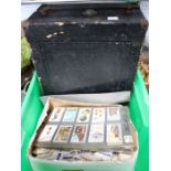 A box with a high number of loose cigarette cards and a vintage gramophone.