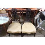 A pair of first quarter 20th century fancy backed low seated chairs, probably from a salon suite
