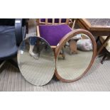 Two oval bevel plate wall mirrors, one oak framed