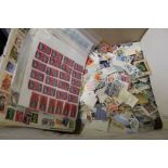 A large quantity of lose stamps in a box