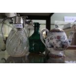 Two glass claret jugs to include 19th century green example and an Ironstone tea pot.