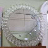A round decorative wall mirror with Lucite moulded frame