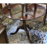 A mahogany fancy edged carved column Tripod table.