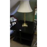 A modernist coffee table and a brass column table lamp.