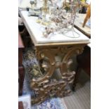 A marble top gilt carved and moulded side table in the Italian style.