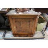 A 19th century small sized oak hanging corner cupboard with single drawer